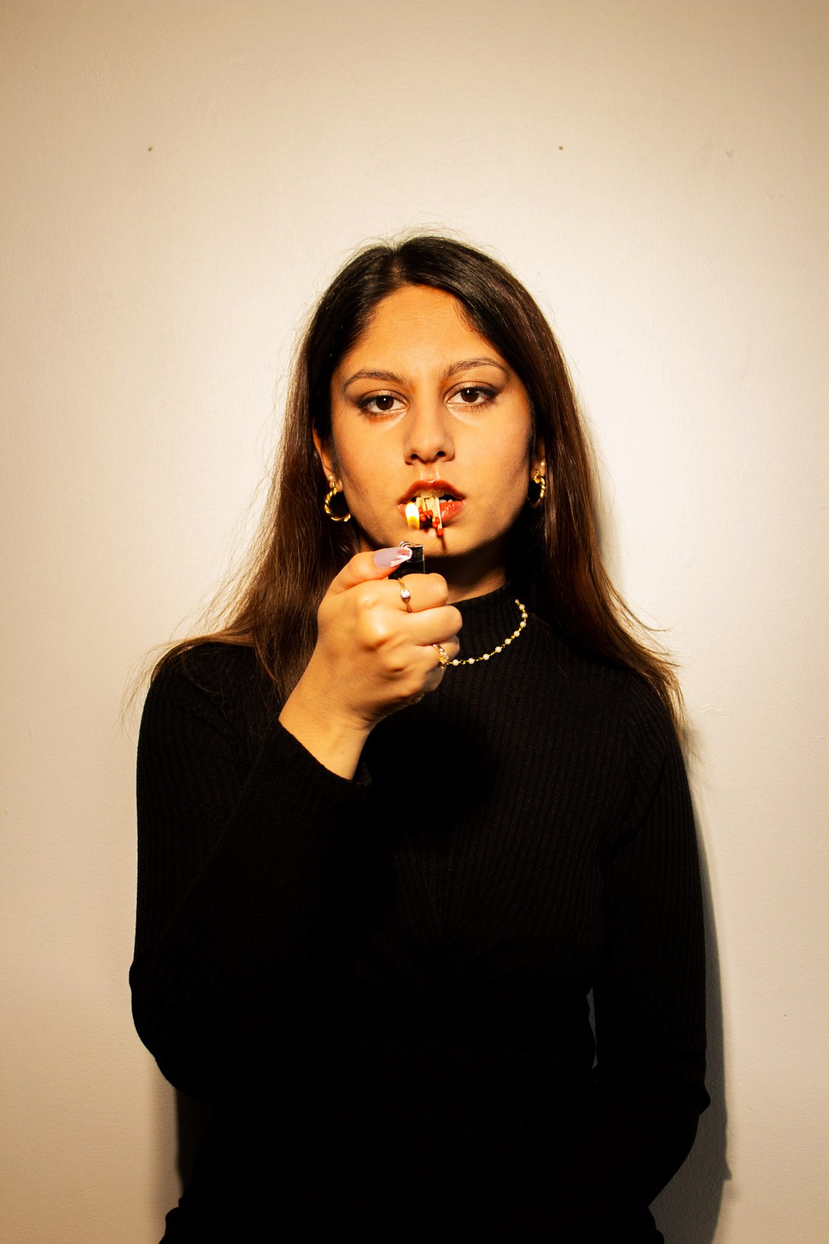 Riha lighting a matchstick, editorial portrait